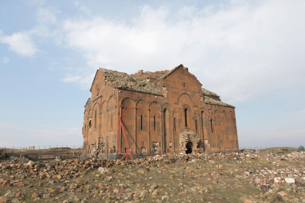 A wide panoramic view of Ani Ruins in eastern Turkey, showcasing the vast archaeological landscape and its position along the historic Silk Road near the Armenian border.