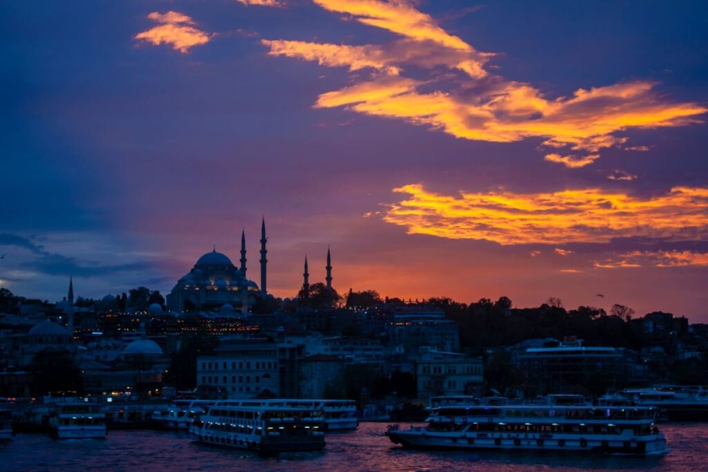 Galata Bridge during sunset with Istanbul skyline in background