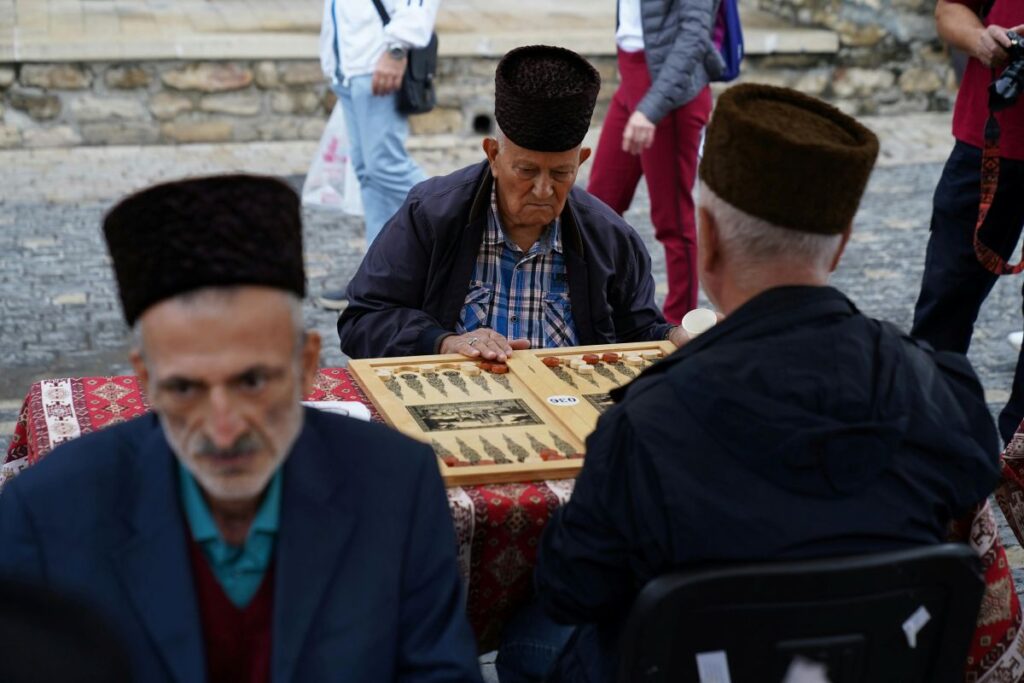 Men playing backgammon in a traditional Turkish coffeehouse