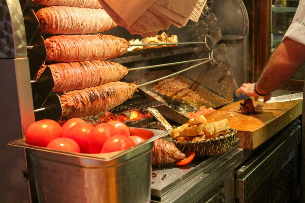 Kokorec being cooked over charcoal at a Turkish street food stall