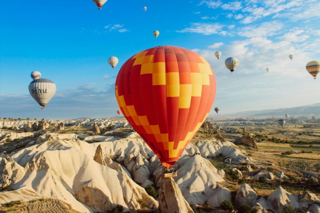 Hot air balloons flying over Cappadocia at sunrise