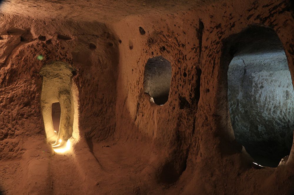 Visitors exploring the underground cities of Cappadocia