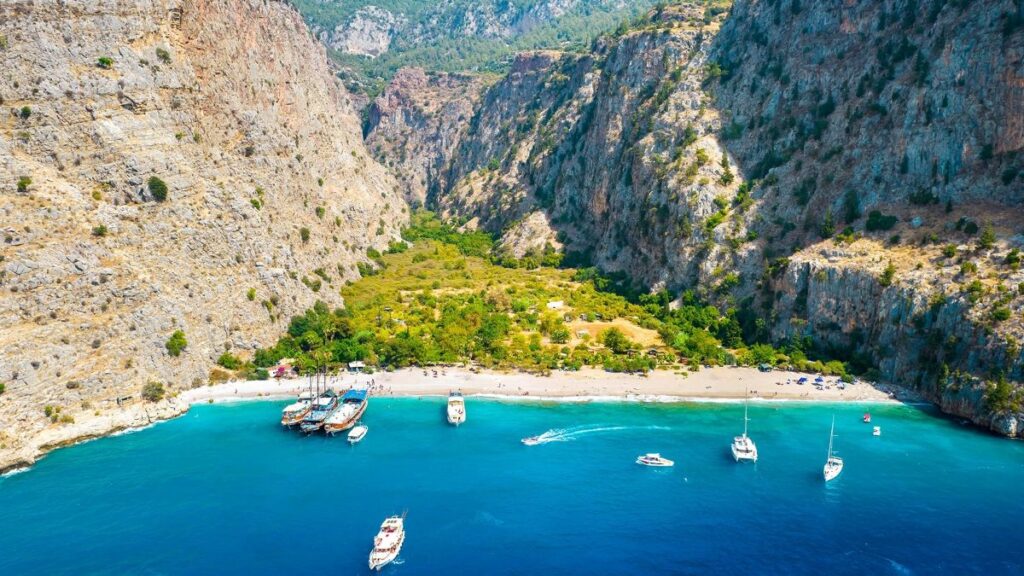 Butterfly Valley beach surrounded by steep cliffs on the Turkish coast